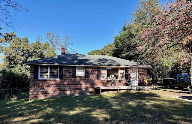 back of house with a lawn