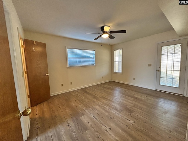 empty room featuring hardwood / wood-style flooring and ceiling fan