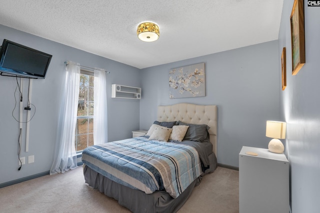 bedroom with a wall mounted AC, light carpet, and a textured ceiling