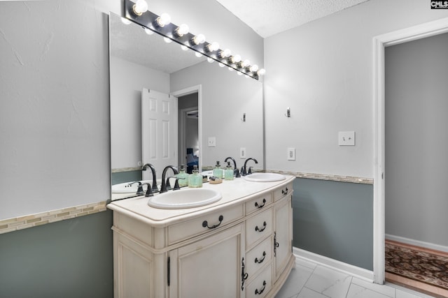 bathroom with vanity and a textured ceiling