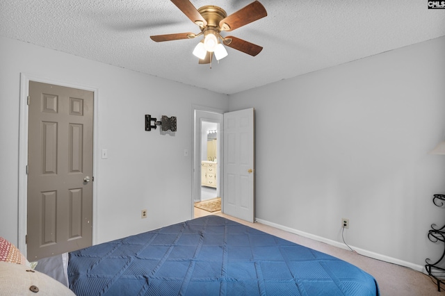 carpeted bedroom with ceiling fan and a textured ceiling