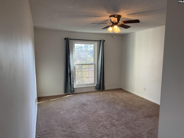 carpeted empty room featuring ceiling fan and a textured ceiling