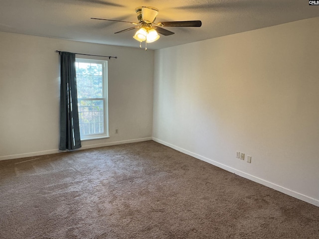 carpeted empty room featuring ceiling fan and a textured ceiling