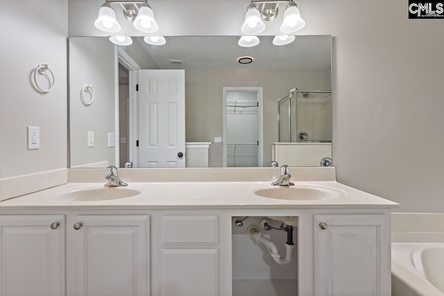 bathroom featuring vanity and shower with separate bathtub