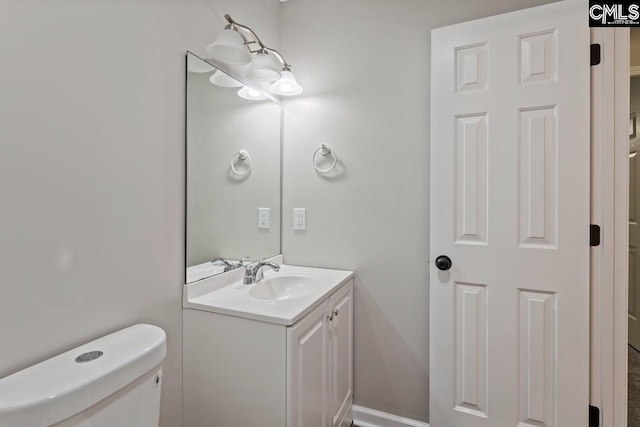 bathroom featuring vanity and toilet