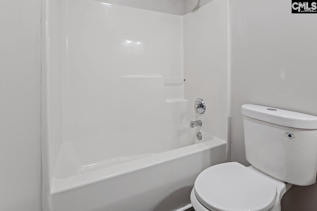 bathroom with shower / bathing tub combination and toilet