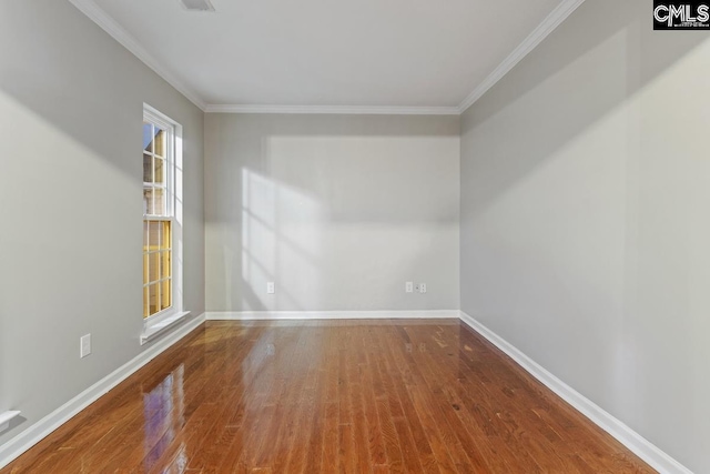 spare room with wood-type flooring and ornamental molding