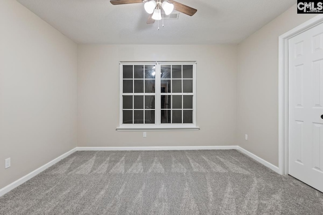 spare room featuring carpet flooring and ceiling fan