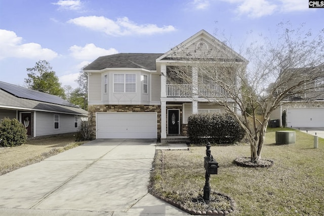 view of front of home with a garage, a balcony, and central AC