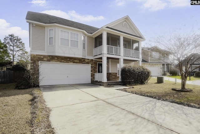 view of front of house with a garage, a balcony, and cooling unit