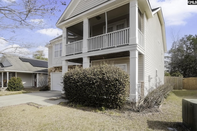 view of home's exterior with a balcony and a garage