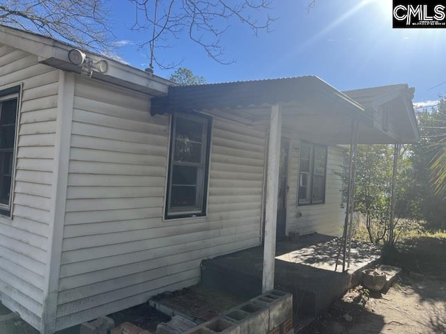 view of property exterior with a patio area