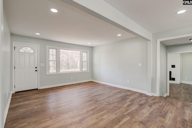 entryway with a fireplace and dark hardwood / wood-style flooring