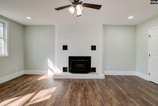 unfurnished living room featuring ceiling fan and dark hardwood / wood-style flooring