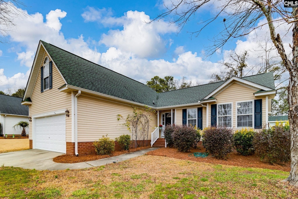 view of front of house with a garage and a front yard