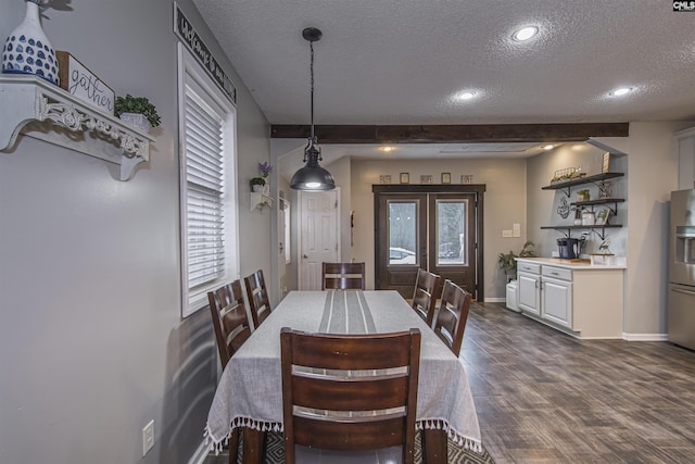 dining space with dark hardwood / wood-style flooring, french doors, and a textured ceiling