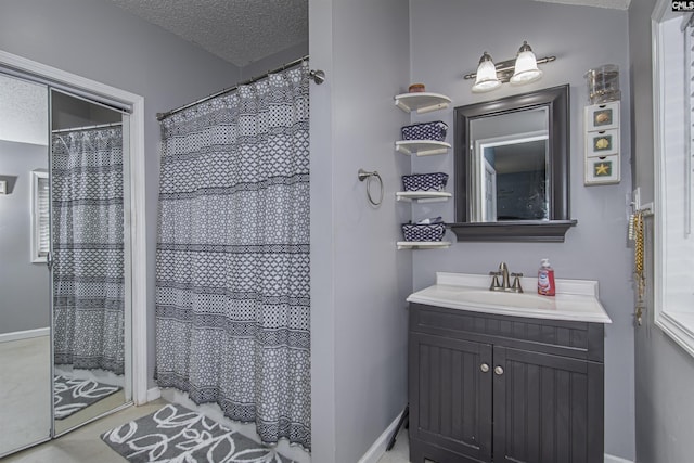 bathroom featuring vanity, a shower with shower curtain, and a textured ceiling