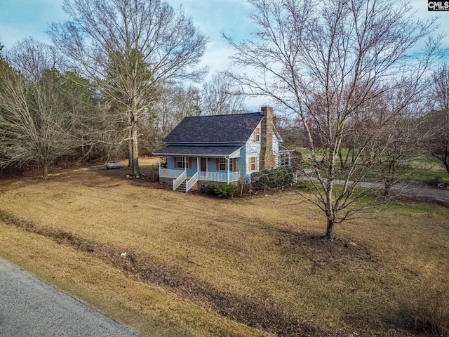 view of side of property featuring a yard and covered porch