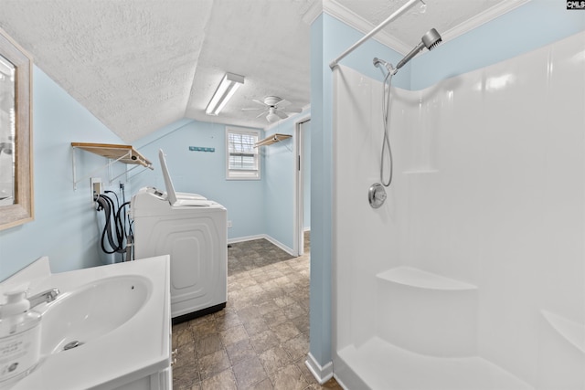 bathroom featuring walk in shower, a textured ceiling, vanity, ceiling fan, and washer / clothes dryer