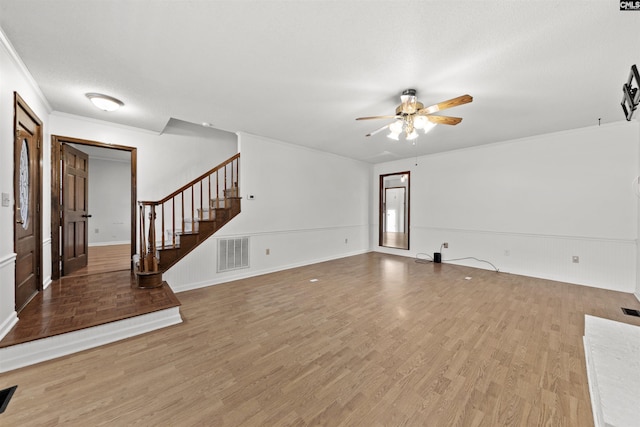 unfurnished living room featuring hardwood / wood-style flooring, ornamental molding, a textured ceiling, and ceiling fan