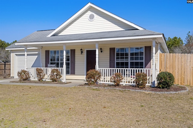 view of front facade featuring a porch, a garage, and a front yard