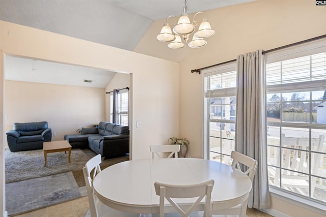 dining space with lofted ceiling, a chandelier, and tile patterned flooring