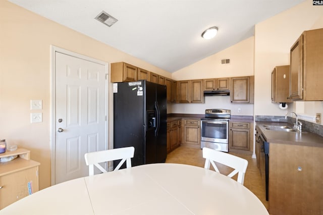 kitchen with black fridge, lofted ceiling, stainless steel electric stove, and sink