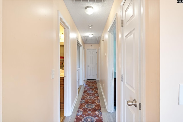 corridor with a textured ceiling