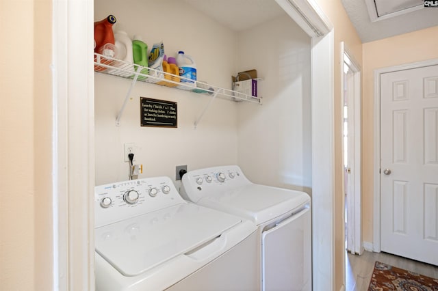 laundry area featuring washer and dryer and hardwood / wood-style floors