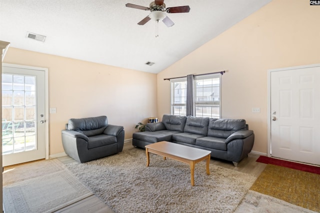 living room with ceiling fan, high vaulted ceiling, and light hardwood / wood-style floors