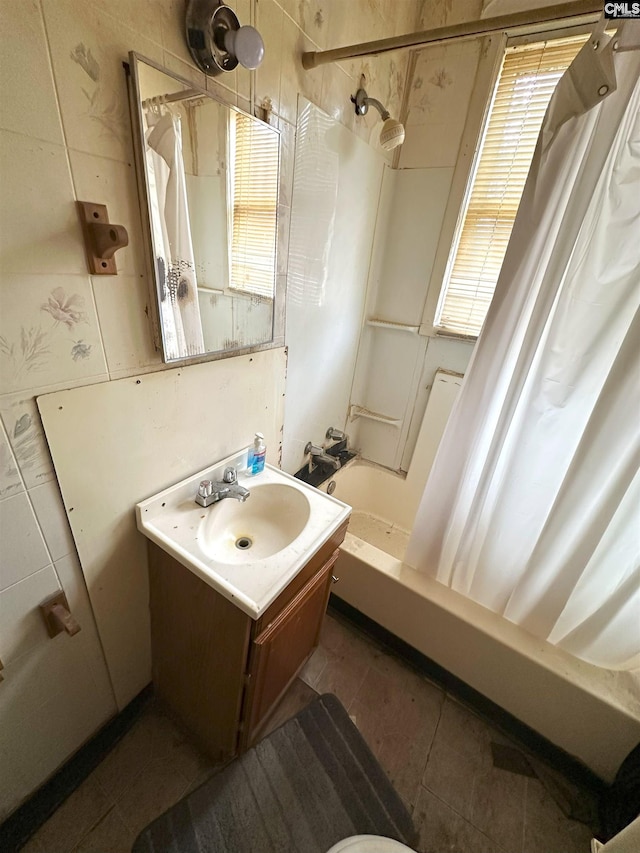 bathroom featuring tile patterned flooring, vanity, and shower / bath combination with curtain