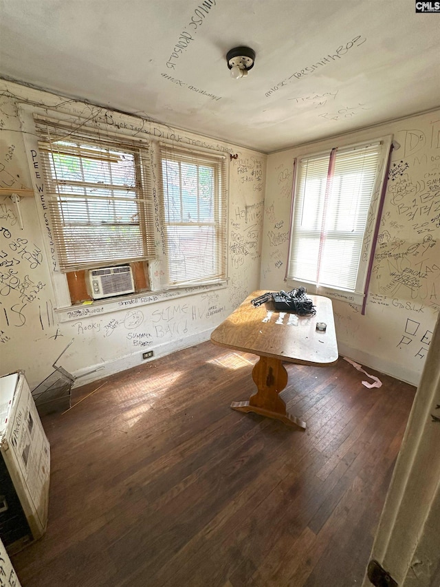 unfurnished dining area featuring cooling unit and hardwood / wood-style floors