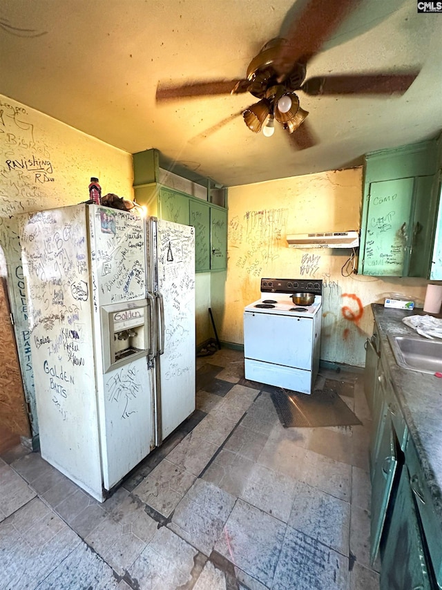 kitchen featuring ceiling fan, sink, green cabinets, and white appliances