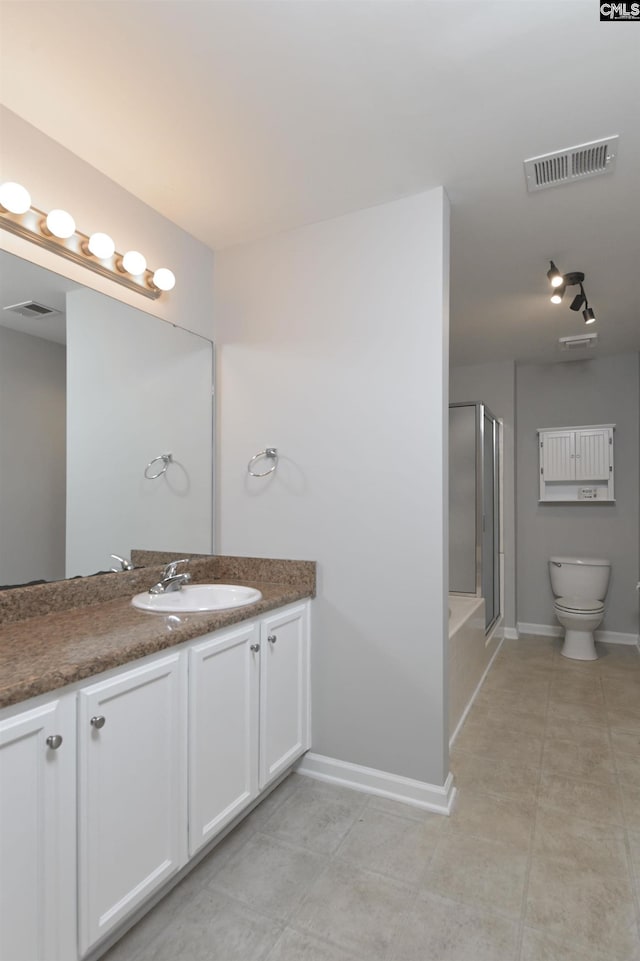 bathroom with vanity, an enclosed shower, tile patterned floors, and toilet