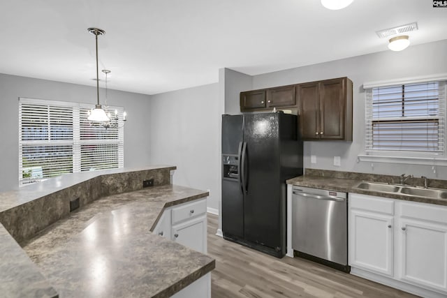 kitchen with black fridge with ice dispenser, decorative light fixtures, light wood-type flooring, stainless steel dishwasher, and white cabinets