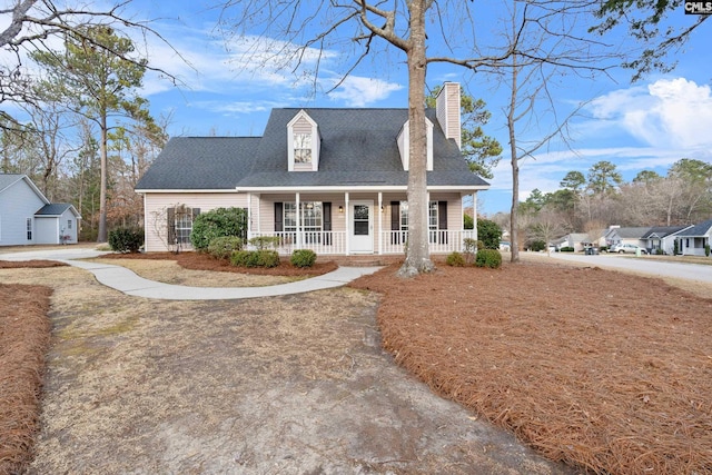 new england style home featuring covered porch