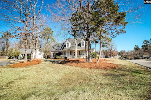 cape cod house featuring a front yard and a porch