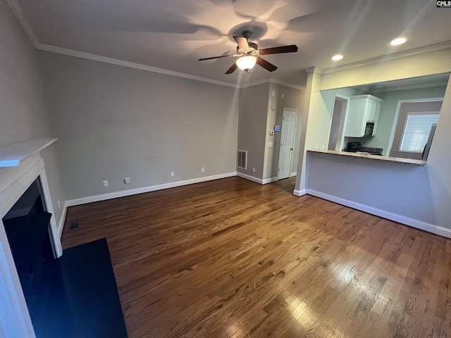 unfurnished living room with hardwood / wood-style flooring, ornamental molding, and ceiling fan