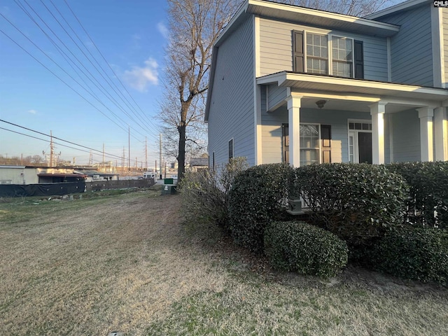 view of side of property with a yard