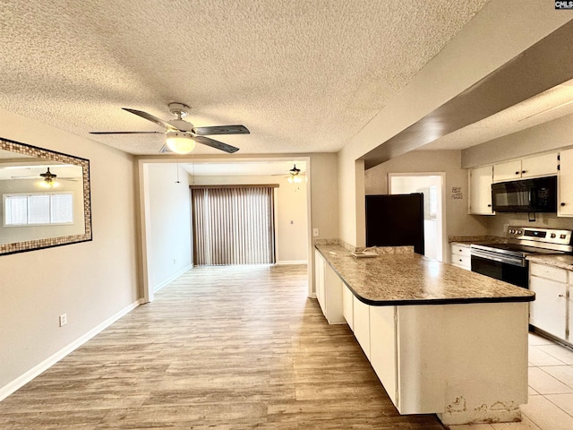 kitchen with stainless steel electric range oven, refrigerator, white cabinetry, ceiling fan, and light wood-type flooring