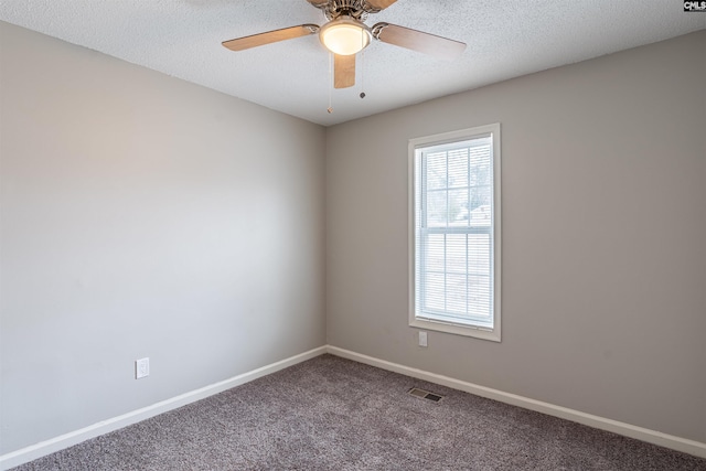 carpeted spare room with ceiling fan and a textured ceiling