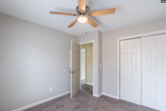 unfurnished bedroom with ceiling fan, carpet floors, a closet, and a textured ceiling