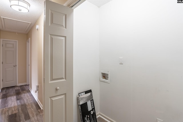 laundry room featuring hookup for a washing machine, dark wood-type flooring, and a textured ceiling