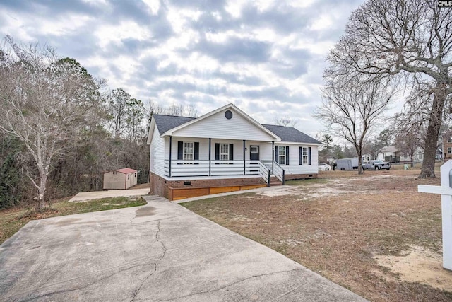 view of front facade featuring a storage unit and covered porch