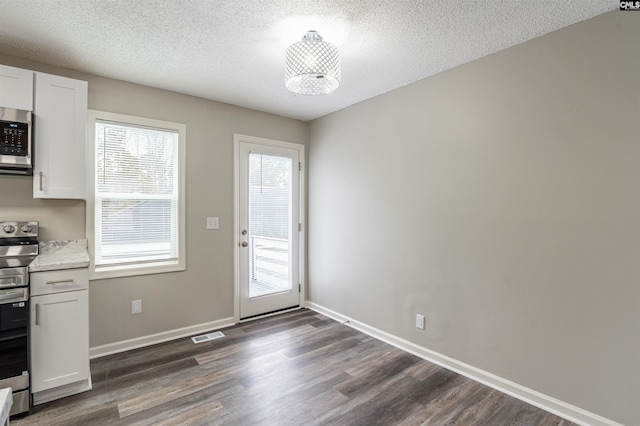 interior space with dark hardwood / wood-style flooring and a textured ceiling