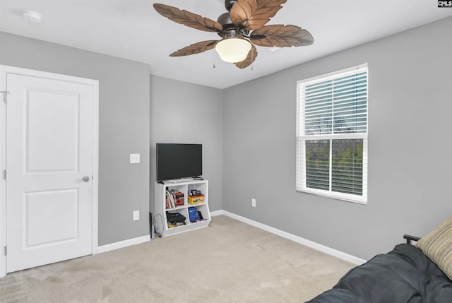 living area featuring ceiling fan and light colored carpet