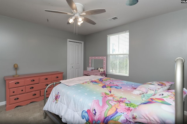 bedroom with a closet, ceiling fan, and carpet flooring