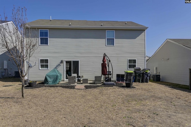 rear view of house featuring central AC unit and a patio area