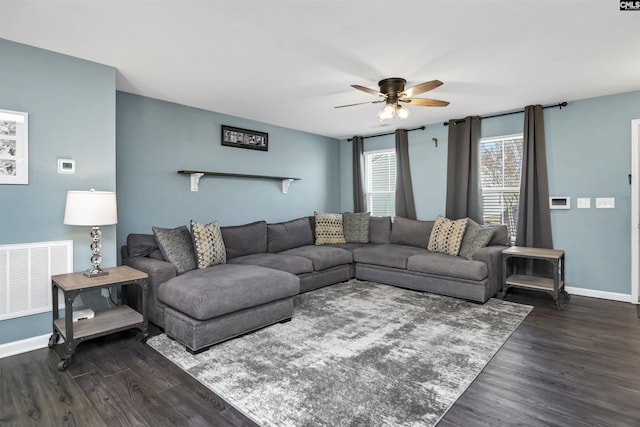 living room featuring dark wood-type flooring and ceiling fan