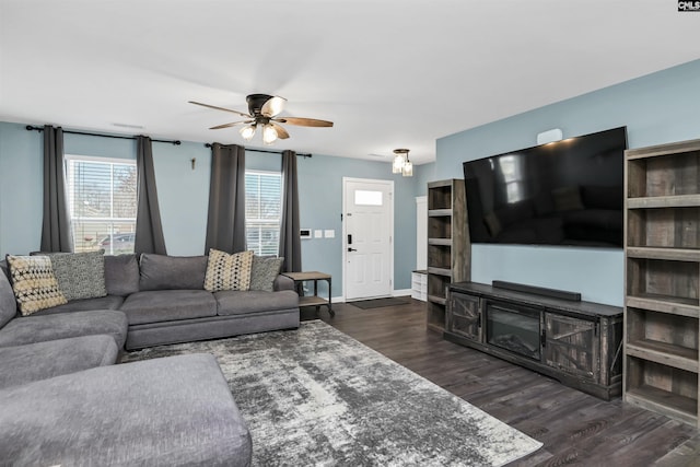 living room featuring ceiling fan and dark hardwood / wood-style floors